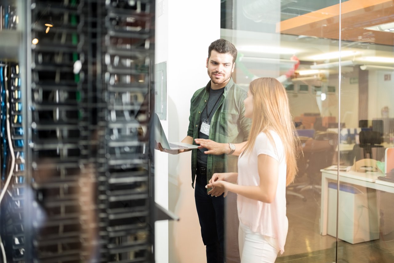 IT team discussing backup and archive strategy in a server room